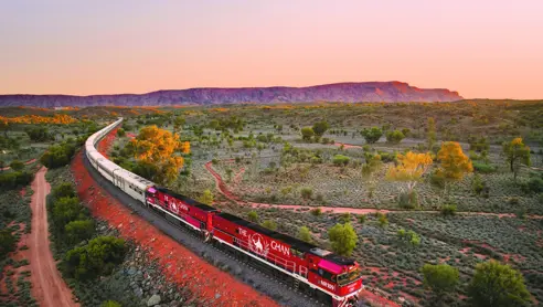 JBRE Ghan Heading North Alice Springs At Sunset Macdonnell Ranges In Background